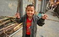 Asian boy 8 years old, playing in street in Chinese countryside. Royalty Free Stock Photo