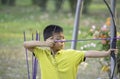 Asian boys are archery in camp adventure Royalty Free Stock Photo