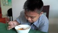 Asian boys eat breakfast like gluttonous. In a hasty life