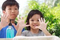 Asian boys and girls aged 4 to 8 years. Cute, bright faces are washing their hands with soap and water, washing hands with soap an