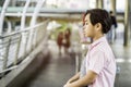 Asian boys sit stress and bad mood alone in the open space of the school, the concept of being bullied Cynicism and racism