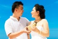 Asian bride and groom on a tropical beach. Wedding and honeymoon Royalty Free Stock Photo