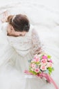 Asian bride sitting and holding a bouquet Royalty Free Stock Photo