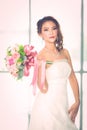 Asian bride standing and holding a bouquet Royalty Free Stock Photo