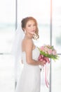 Asian bride standing and holding a bouquet Royalty Free Stock Photo