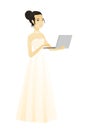 Asian bride in a white dress using a laptop.