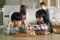 asian brother and sister playing chess at home Royalty Free Stock Photo