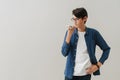 Asian brunette boy wearing eyeglasses talking on cellphone Royalty Free Stock Photo