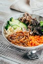 Asian buddha bowl on concrete table background. Delicious food concept