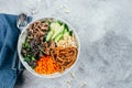 Asian buddha bowl on concrete table baclground. Grilled beef, carrot, cucumber, sprouted mung bean