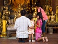 Asian Buddhist Family Making Offerings at Temple in Ayutthaya, T