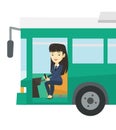 Asian bus driver sitting at steering wheel.