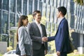 Asian business associates shaking hands outdoors Royalty Free Stock Photo