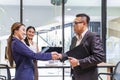 Asian business CEO congratulate female employee for the outstanding achievement of her team performance by shaking hand in the Royalty Free Stock Photo