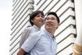 Asian business father and son confidence child want to be like a his dad parent and young boy standing in city with cityscape Royalty Free Stock Photo