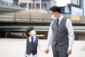 Asian business father and son are wearing face masks to prevent pollution and coronavirus in the city. Family businessman and son