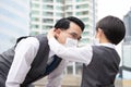 Asian business father and son are wearing face masks to prevent pollution and coronavirus in the city. Family businessman and son