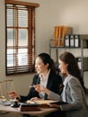 Asian Business and lawyers discussing contract papers with brass scale on desk in office. Law, legal services, advice, justice Royalty Free Stock Photo