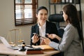 Asian Business and lawyers discussing contract papers with brass scale on desk in office. Law, legal services, advice, justice Royalty Free Stock Photo