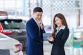 Asian business man bargain purchasing brand new car, Car rental business in auto showroom Royalty Free Stock Photo