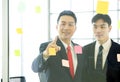 Asian business man in black suit pointing finger at mind map for business plan on the glass panel. There was a note paper on the Royalty Free Stock Photo