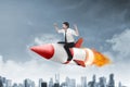 Asian business man flying ride rocket Royalty Free Stock Photo