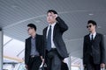 Asian business man with group of bodyguard walking on business s