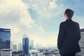 Asian business man looking the city from the rooftop Royalty Free Stock Photo