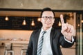 An Asian business man is pointing with left hand. Royalty Free Stock Photo