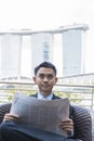 Asian Business man reading a newspaper Royalty Free Stock Photo