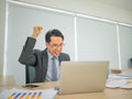 Asian business man sitting very happy Royalty Free Stock Photo