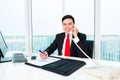 Asian business man telephoning in office Royalty Free Stock Photo