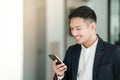 Asian business man using cell phone. Having Conversation, typing sms or presenting. Royalty Free Stock Photo