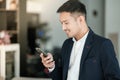 Asian business man using cell phone. Having Conversation, typing sms or presenting. Royalty Free Stock Photo