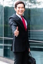 Asian business man walking in front of building Royalty Free Stock Photo