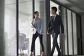Asian business man and woman walking talking in office Royalty Free Stock Photo