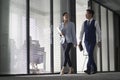 asian business man and woman walking talking in office Royalty Free Stock Photo