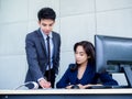 Asian business man and woman wearing suit working together in office