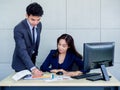 Asian business man and woman wearing suit working together in office Royalty Free Stock Photo
