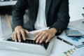 Asian business man working at office with laptop and documents on his desk, financial adviser analyzing data Royalty Free Stock Photo