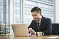 asian business man working in office using laptop computer Royalty Free Stock Photo