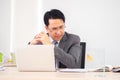 Asian business man in working room. Serious and thinking action. Royalty Free Stock Photo