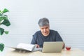 Asian business men Feeling stressed While he looks at unsuccessful earning from a paper report Royalty Free Stock Photo