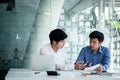 Asian business men meeting and discuss work project at office desk. Business professional teamwork coworkers discussing