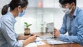 Asian business man showing investment amount on calculator to partner and discussion about new project Royalty Free Stock Photo