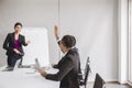 Asian business people in board room meeting,Team group discussing with hand raise up together in conference at office,Question and Royalty Free Stock Photo