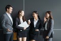 Asian business people discussion front of office building. Young businessman and businesswoman colleague talk in the break Royalty Free Stock Photo