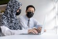 Asian business people group wearing protection face mask working and communicating at modern office desk together, brainstorm, dig Royalty Free Stock Photo