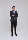 asian business people man good looking in studio. Full length Asian businessman in grey suit confident with crossed arms Royalty Free Stock Photo