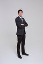 asian business people man good looking in studio. Full length Asian businessman in grey suit confident with crossed arms isolated Royalty Free Stock Photo